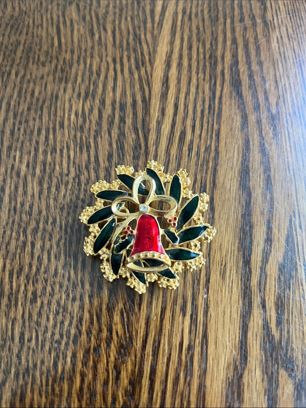 Gold-Tone Holiday Bell Brooch with Green Leaves